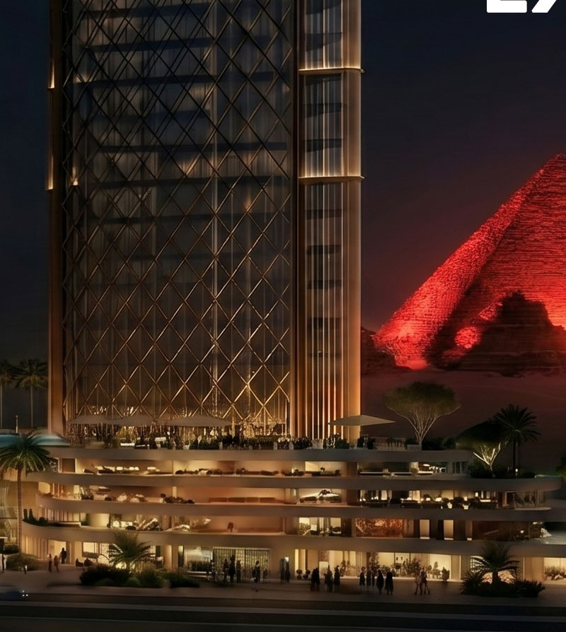 Triumph Pyramids tower lit against the Great Pyramid